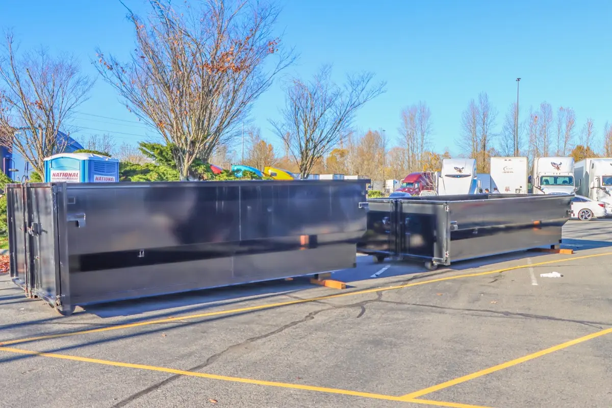 Professional dumpster rental service with roll-off container on residential driveway in Swissvale